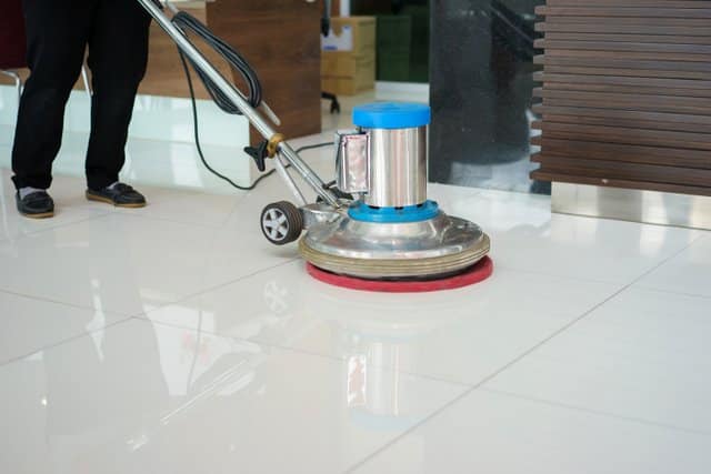 cleaning floor with machine.
